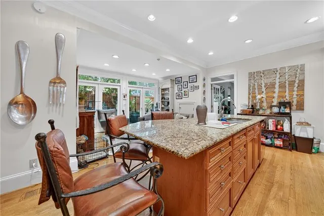 a dining hall with stainless steel appliances granite countertop a stove and a dining table