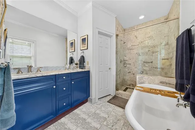 a bathroom with a tub sink toilet and mirror