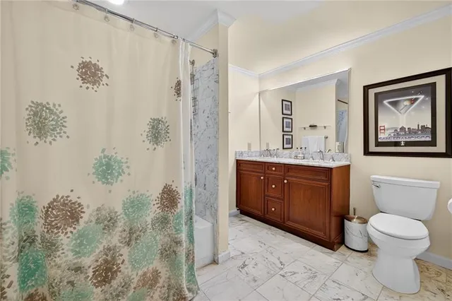 a bathroom with a granite countertop sink a toilet and a bathtub