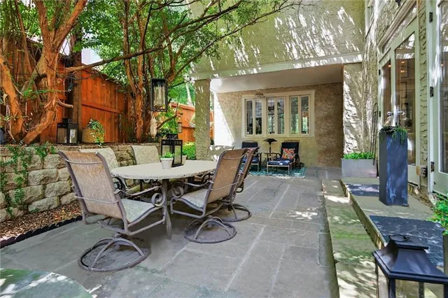 a view of a patio with table and chairs and potted plants
