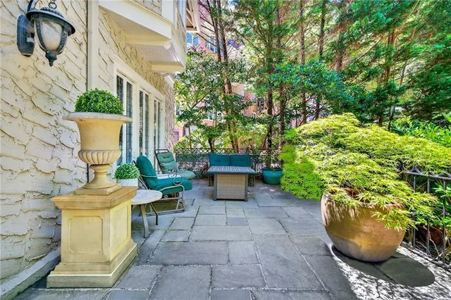 a view of a patio with table and chairs and potted plants