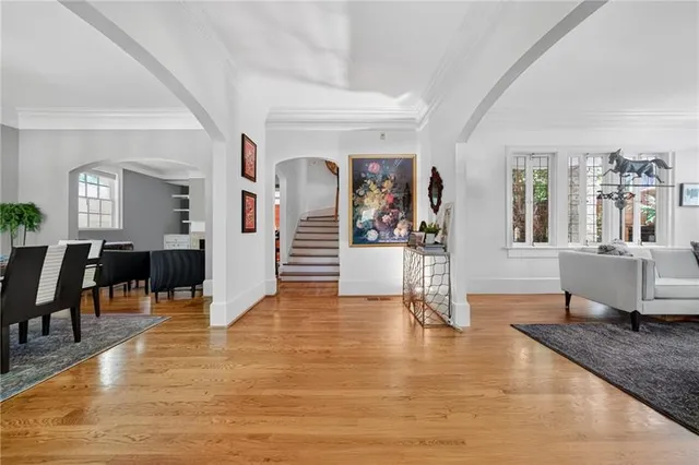 a living room with furniture and wooden floors