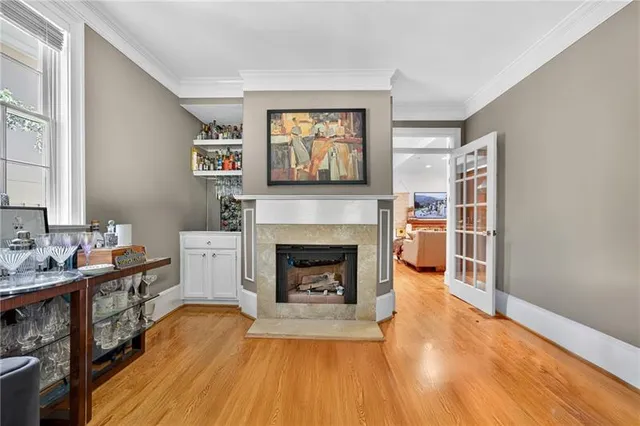 a living room with furniture a fireplace and a wooden floor