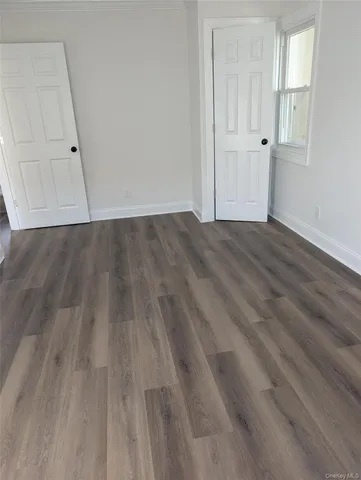 a view of a room with wooden floor