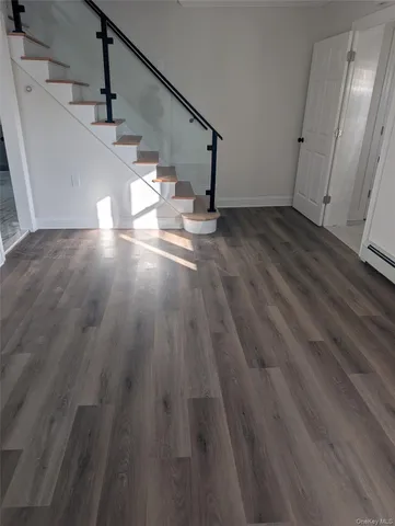a view of entryway and hall with wooden floor