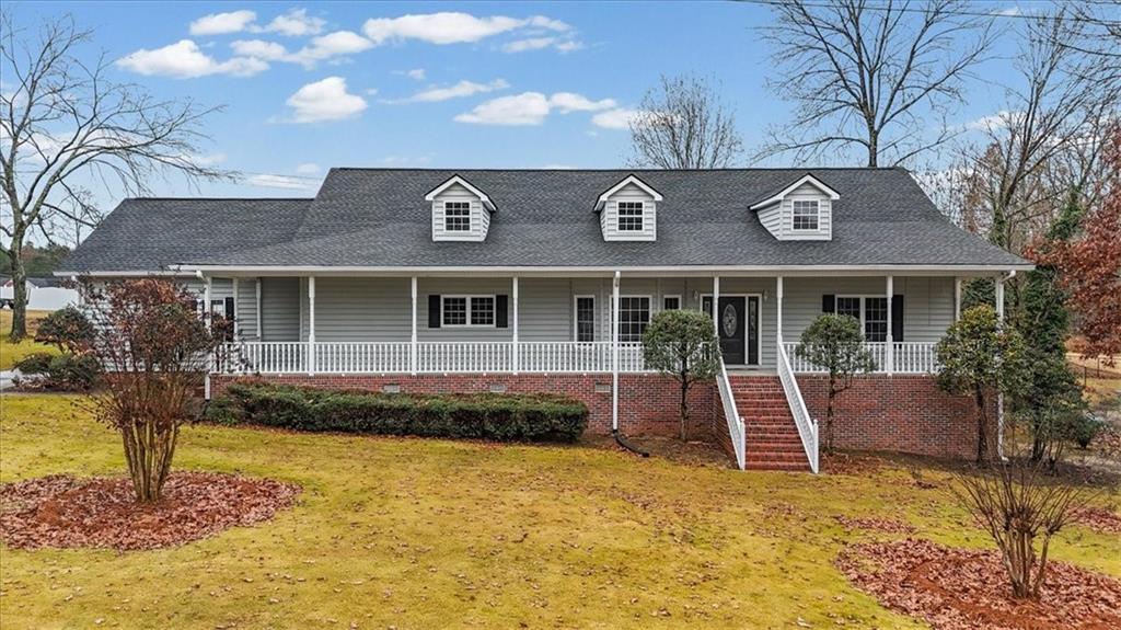 a view of a house with swimming pool and sitting area