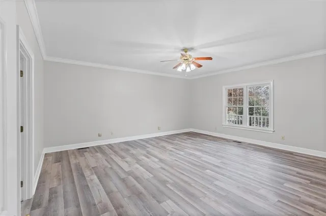 wooden floor in an empty room with a window