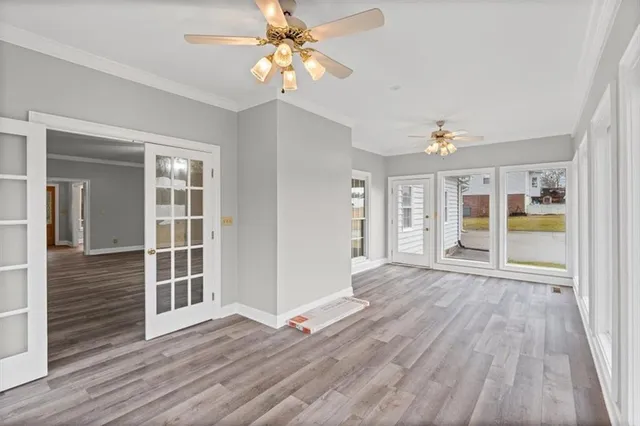 wooden floor in an empty room with a window