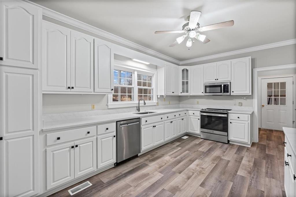 4003 Garden Lakes Parkway Rome, GA 30165 - Photo 4 of 20 a kitchen with granite countertop white cabinets white stainless steel appliances with a sink and dishwasher