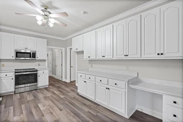 a kitchen with white cabinets and white appliances