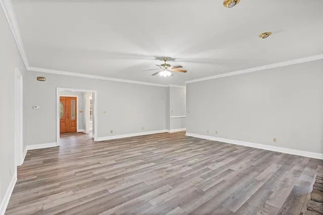 a view of an empty room with wooden floor