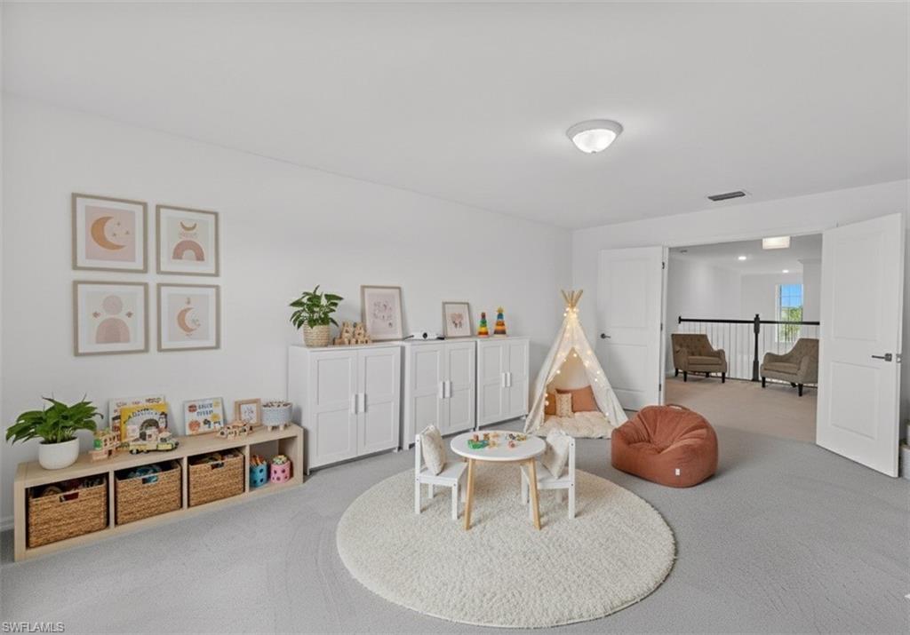 2118 Hamlin Street Naples, FL 34120 - Photo 11 of 41 a living room with furniture a table and a chandelier