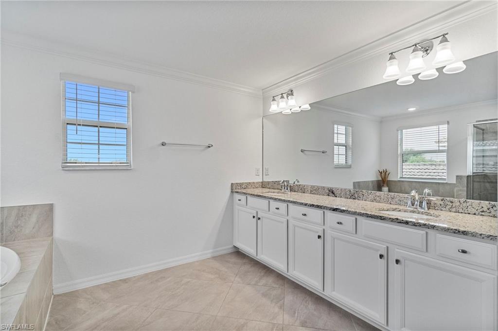 2118 Hamlin Street Naples, FL 34120 - Photo 13 of 41 a bathroom with a granite countertop double vanity sink and a mirror