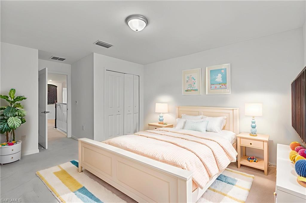 2118 Hamlin Street Naples, FL 34120 - Photo 16 of 41 a bedroom with a bed and a potted plant