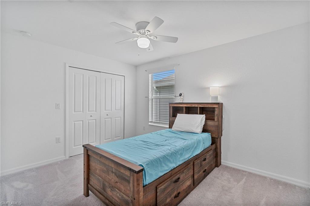 2118 Hamlin Street Naples, FL 34120 - Photo 17 of 41 a bedroom with a bed and a chandelier