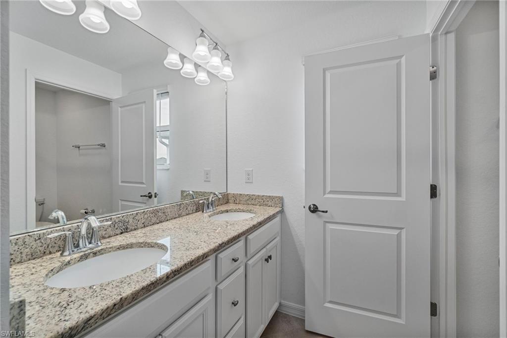2118 Hamlin Street Naples, FL 34120 - Photo 19 of 41 a bathroom with a granite countertop sink and a mirror