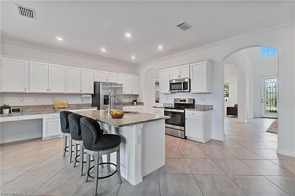 2118 Hamlin Street Naples, FL 34120 - Photo 2 of 41 a kitchen with a sink a counter top space stainless steel appliances and cabinets
