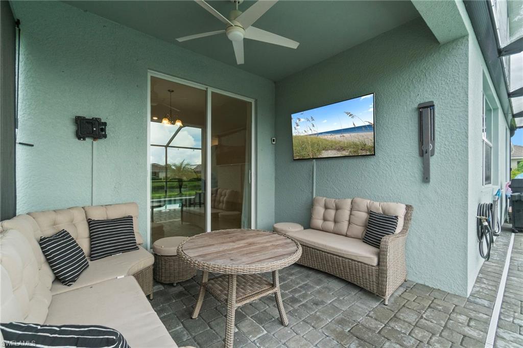 2118 Hamlin Street Naples, FL 34120 - Photo 23 of 41 a bedroom with furniture and a floor to ceiling window