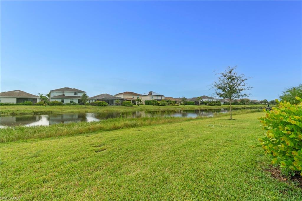 2118 Hamlin Street Naples, FL 34120 - Photo 27 of 41 a view of a lake with houses in the background