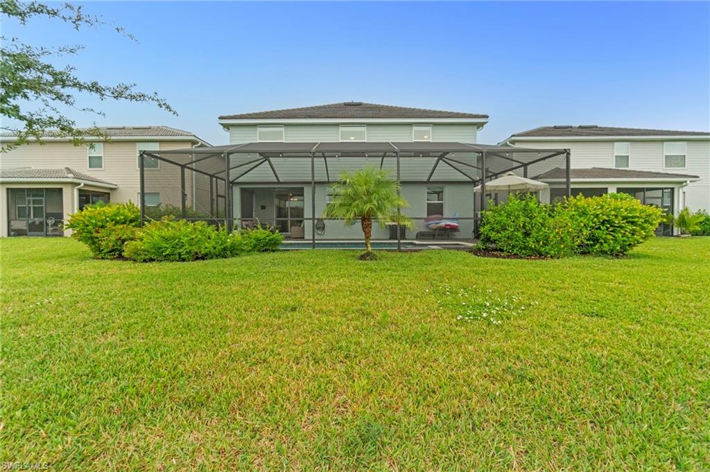 2118 Hamlin Street Naples, FL 34120 - Photo 29 of 41 a front view of house with yard and green space