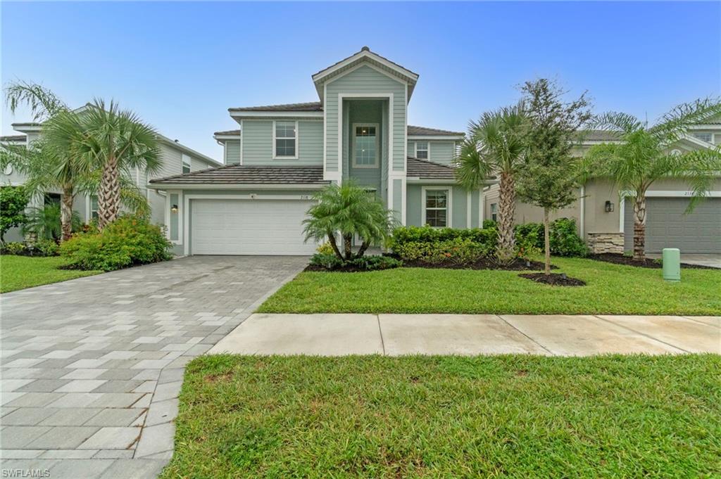 2118 Hamlin Street Naples, FL 34120 - Photo 3 of 41 a front view of a house with a yard