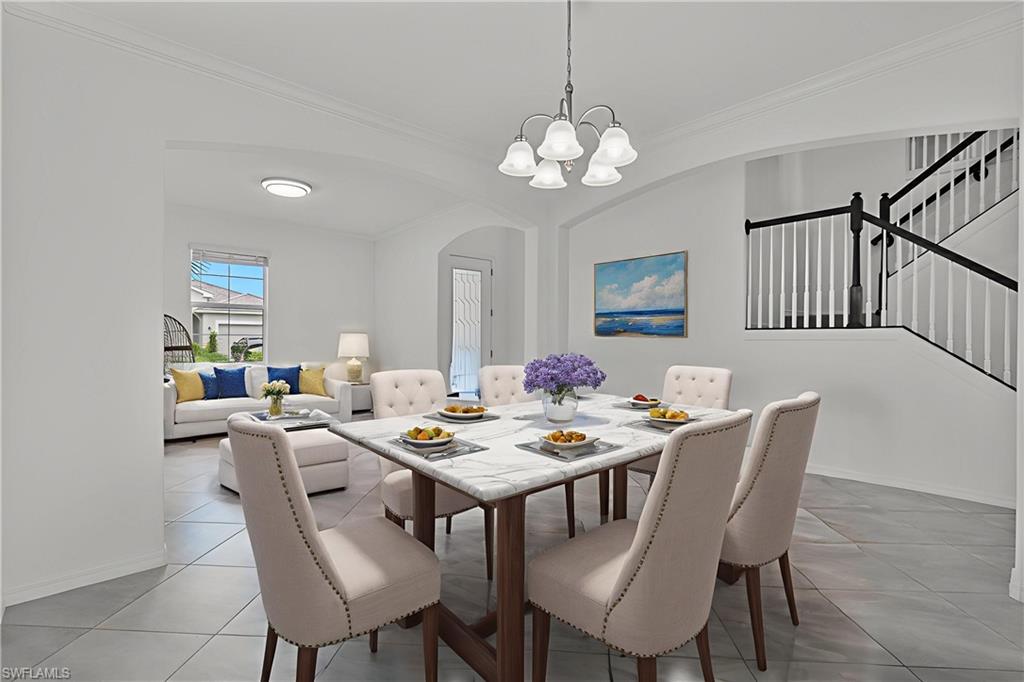 2118 Hamlin Street Naples, FL 34120 - Photo 6 of 41 a view of a dining room with furniture a chandelier and wooden floor