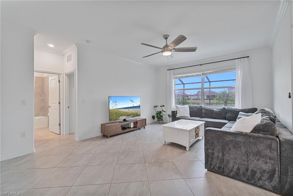 2118 Hamlin Street Naples, FL 34120 - Photo 7 of 41 a living room with furniture and a flat screen tv