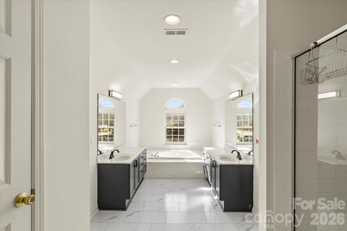 7215 Conifer Circle Indian Trail, NC 28079 - Photo 19 of 34 a bathroom with a sink a mirror and a bathtub