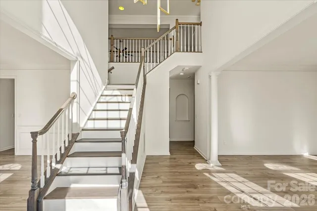 a view of entryway and hall with wooden floor