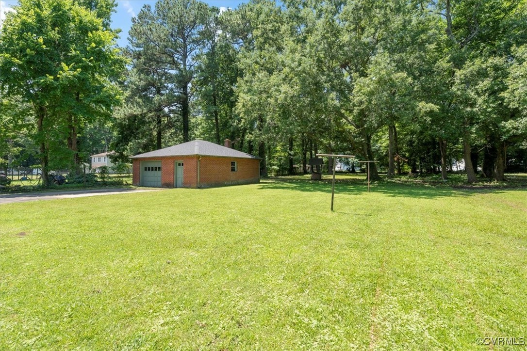 43 Franktown Road Hampton, VA 23663 - Photo 9 of 47 View of grassy yard featuring a garage, driveway,