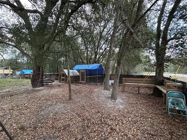 a view of a backyard with sitting area