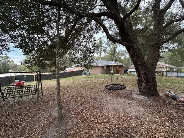 a view of a yard with a tree
