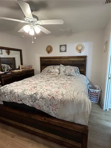 a bed sitting in a bedroom and night stand