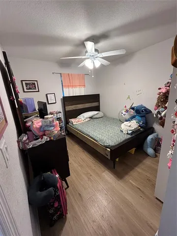 a bedroom with furniture and a chandelier