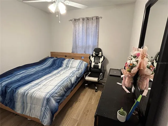 a bed sitting in a bedroom next to a window