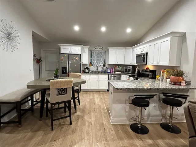 a kitchen with granite countertop counter top space a sink appliances and cabinets