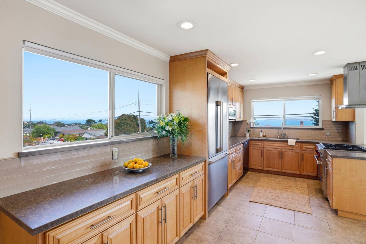 701 Archer Street Monterey, CA 93940 - Photo 7 of 39 a kitchen with stainless steel appliances granite countertop a stove a sink and a refrigerator