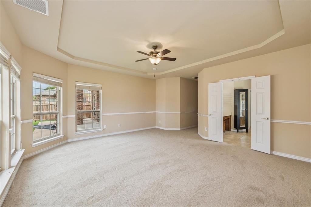 425 Windward Drive Murphy, TX 75094 - Photo 27 of 31 an empty room with chandelier fan and windows