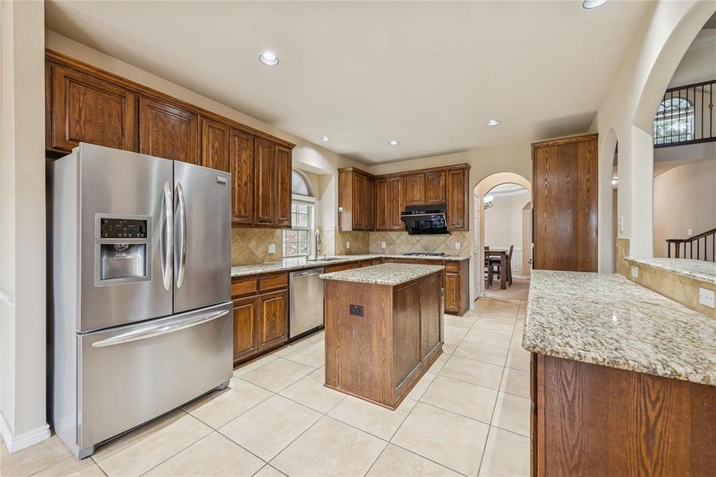 425 Windward Drive Murphy, TX 75094 - Photo 4 of 31 a kitchen with stainless steel appliances granite countertop a refrigerator stove top oven and sink