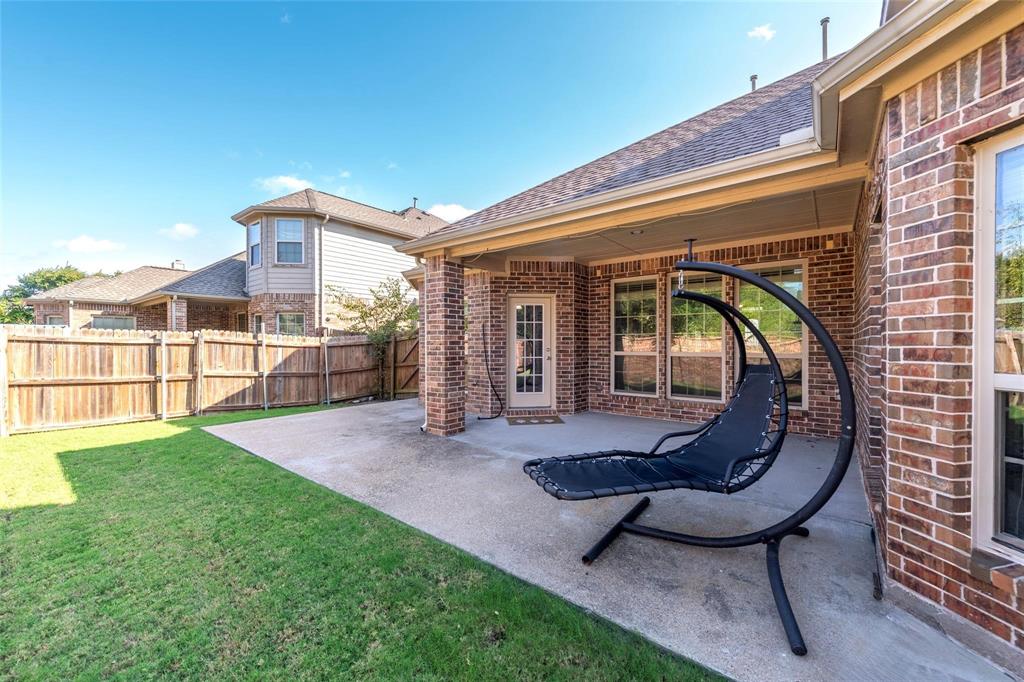 425 Windward Drive Murphy, TX 75094 - Photo 7 of 31 a view of a chair and table in backyard of the house