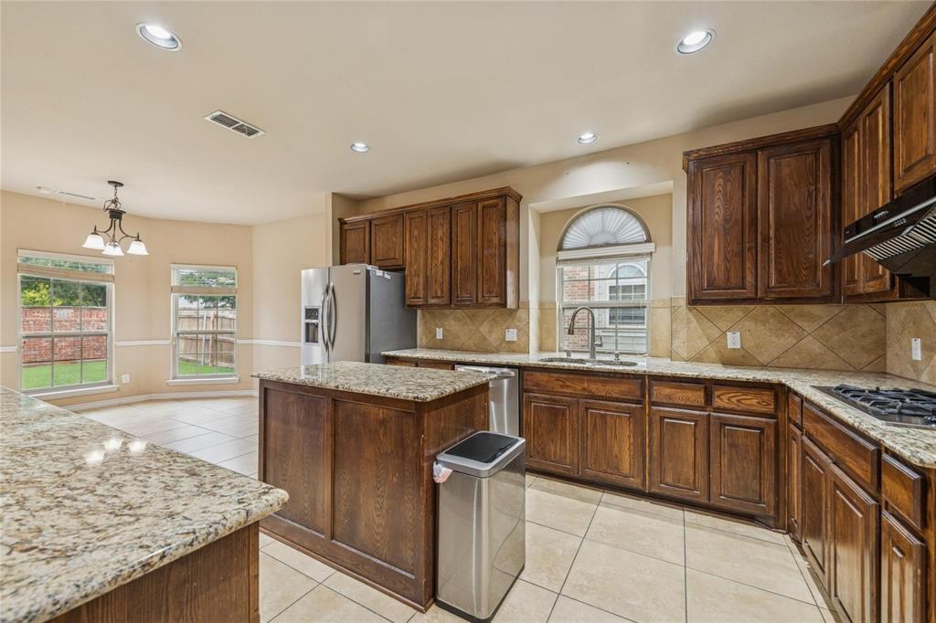 425 Windward Drive Murphy, TX 75094 - Photo 9 of 31 a kitchen with stainless steel appliances granite countertop a sink stove and refrigerator