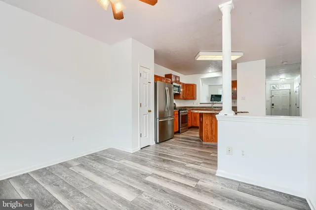 a kitchen with stainless steel appliances granite countertop a refrigerator a stove and a sink