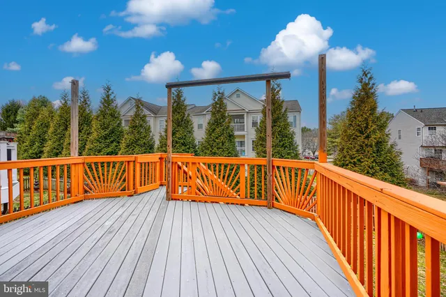 a view of a wooden balcony with large windows