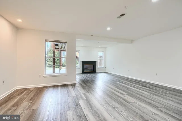 a view of a room with wooden floor