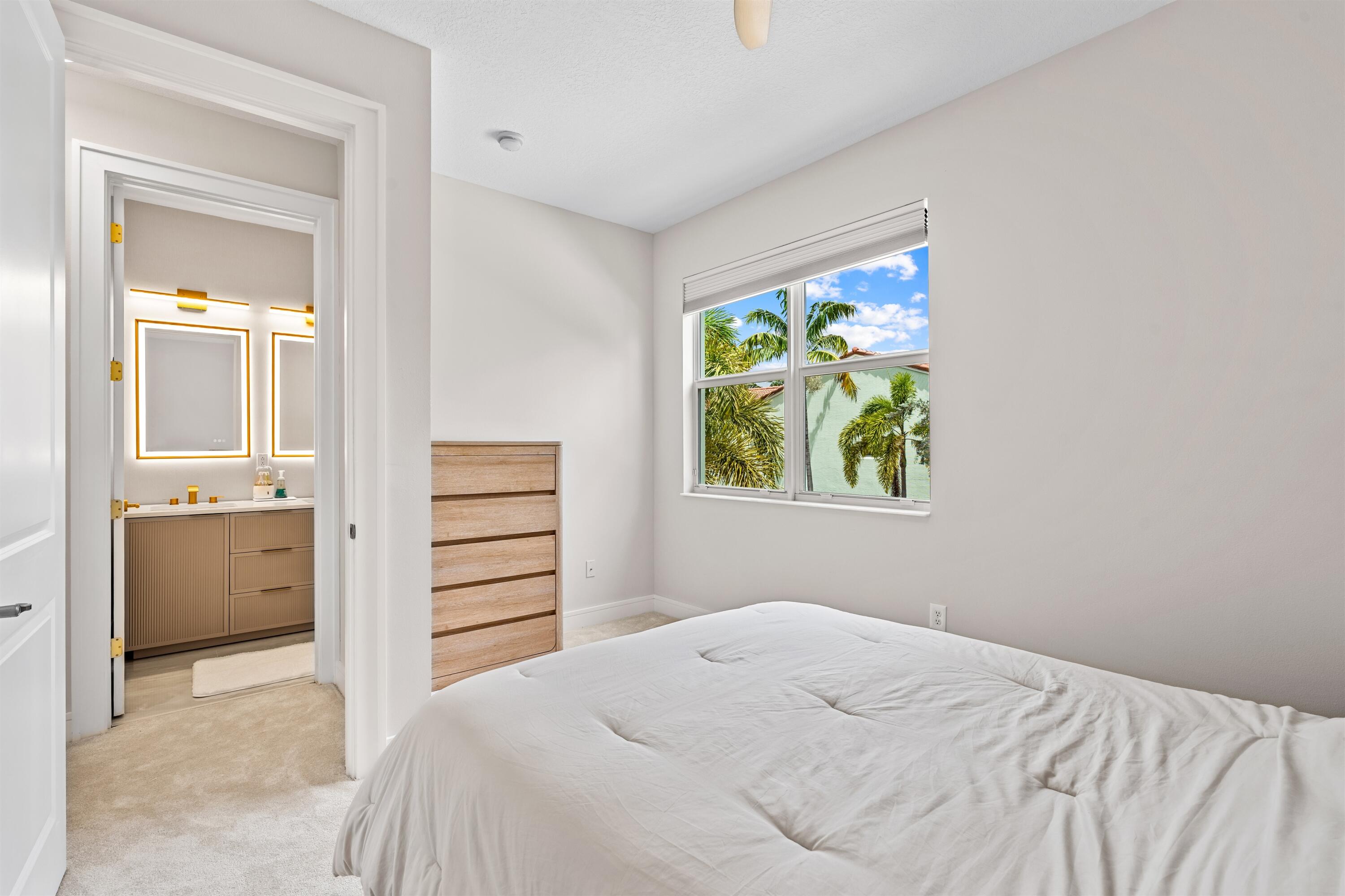 1570 Northwest 48th Place Boca Raton, FL 33431 - Photo 23 of 30 a bedroom with a bed and a window