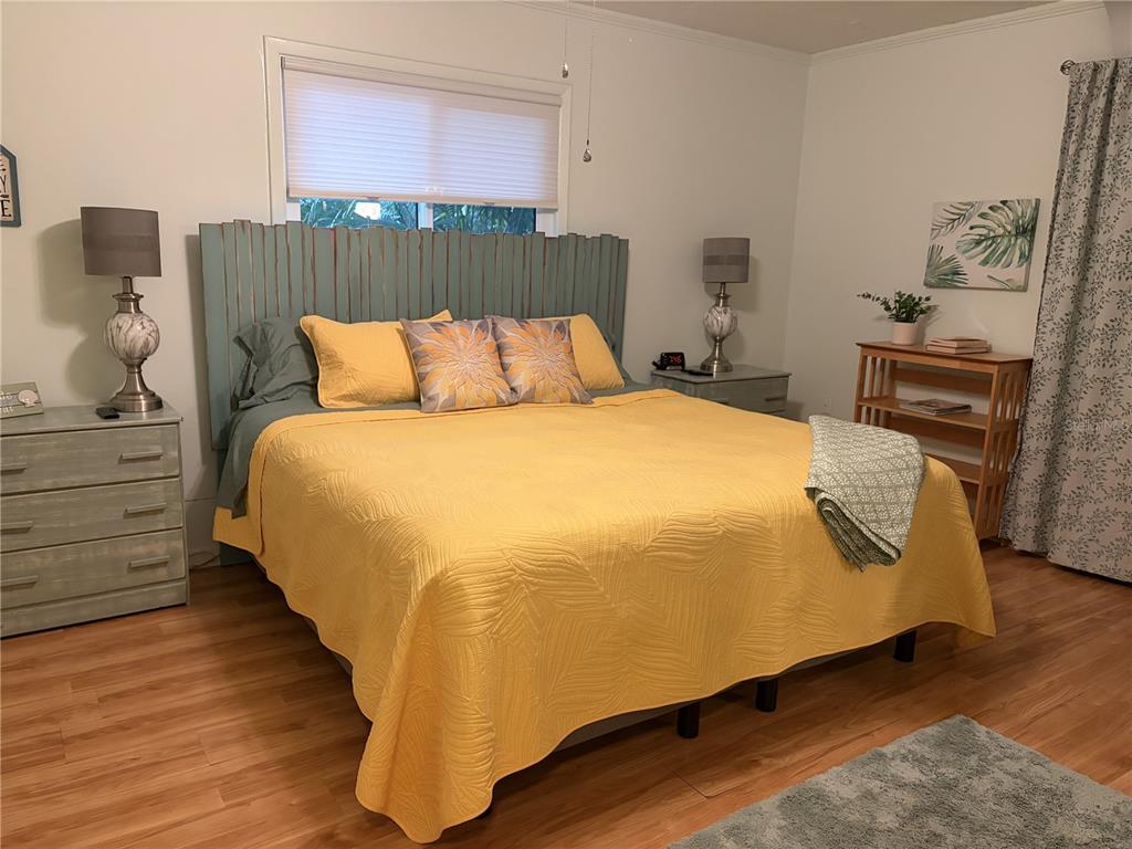 421 Riviera Street Venice, FL 34285 - Photo 11 of 30 a bedroom with a bed and wooden floor