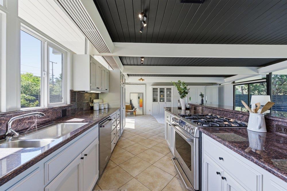 2203 Allegheny Way San Mateo, CA 94402 - Photo 6 of 56 a kitchen with stainless steel appliances a sink stove and cabinets