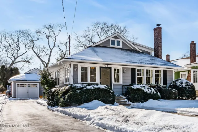 a view of a house with a yard covered in snow