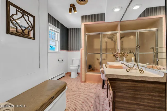 a bedroom with a bed a book shelf and a window