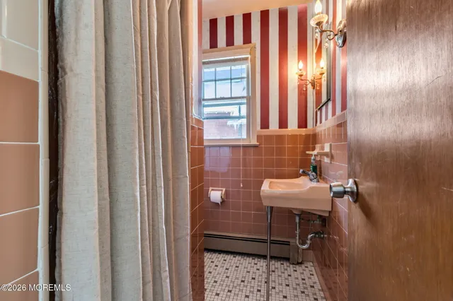 a white toilet sitting next to a bathroom sink and vanity